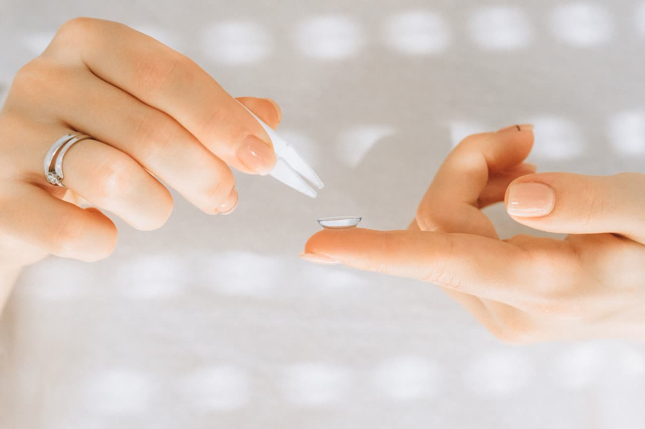 A contact lens on a fingertip